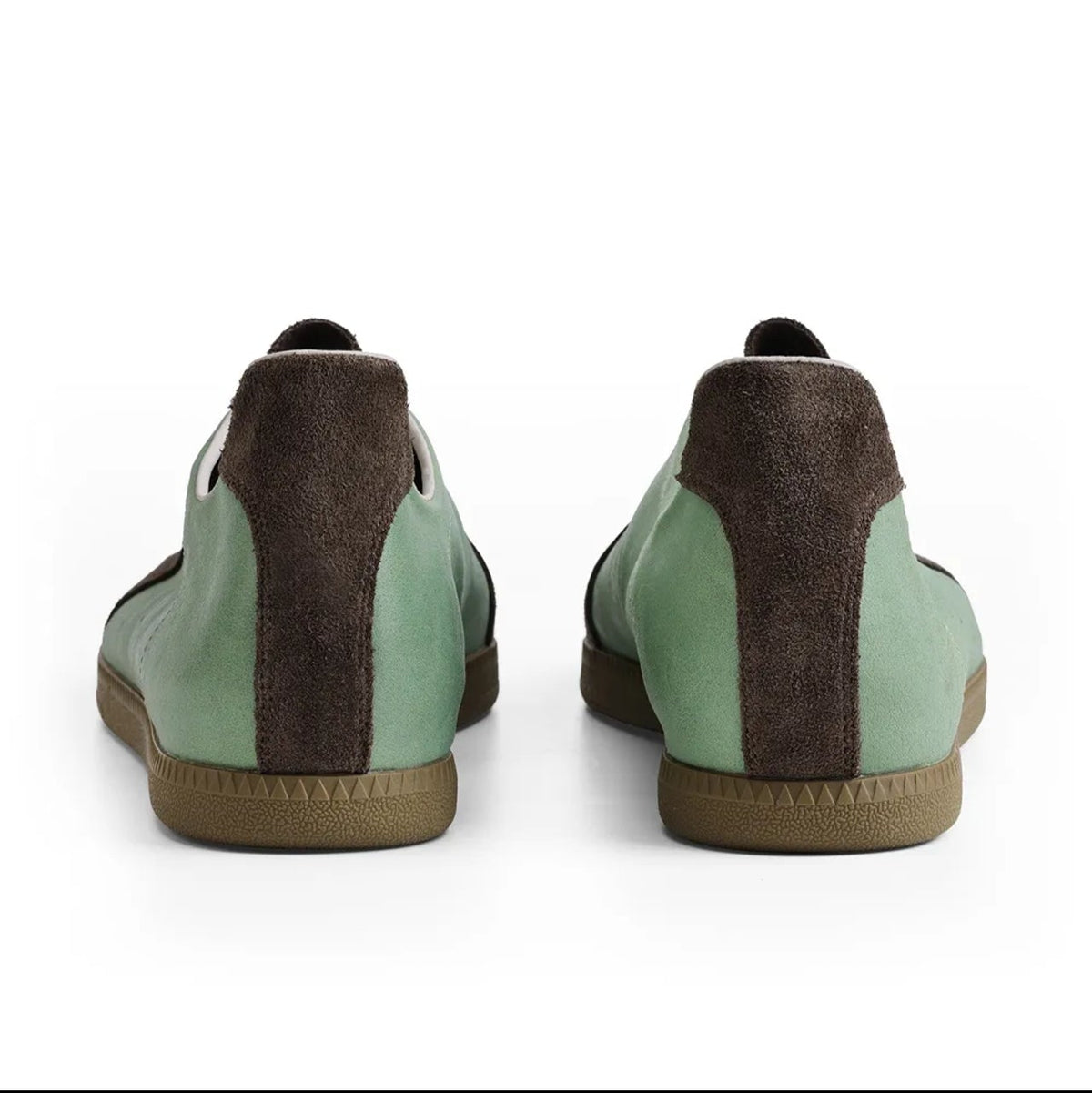 A pair of low-top casual shoes shown from the back, featuring mint green panels, dark brown suede-like side panels, and tan soles, displayed on a white background within a mobile app screenshot.