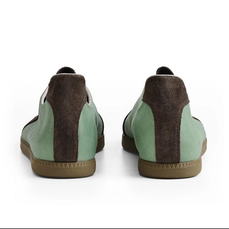A pair of low-top casual shoes shown from the back, featuring mint green panels, dark brown suede-like side panels, and tan soles, displayed on a white background within a mobile app screenshot.