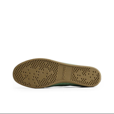 A close-up of a shoe's outsole showing a brown rubber tread with circular grip patterns, photographed on a white background within a mobile app interface.