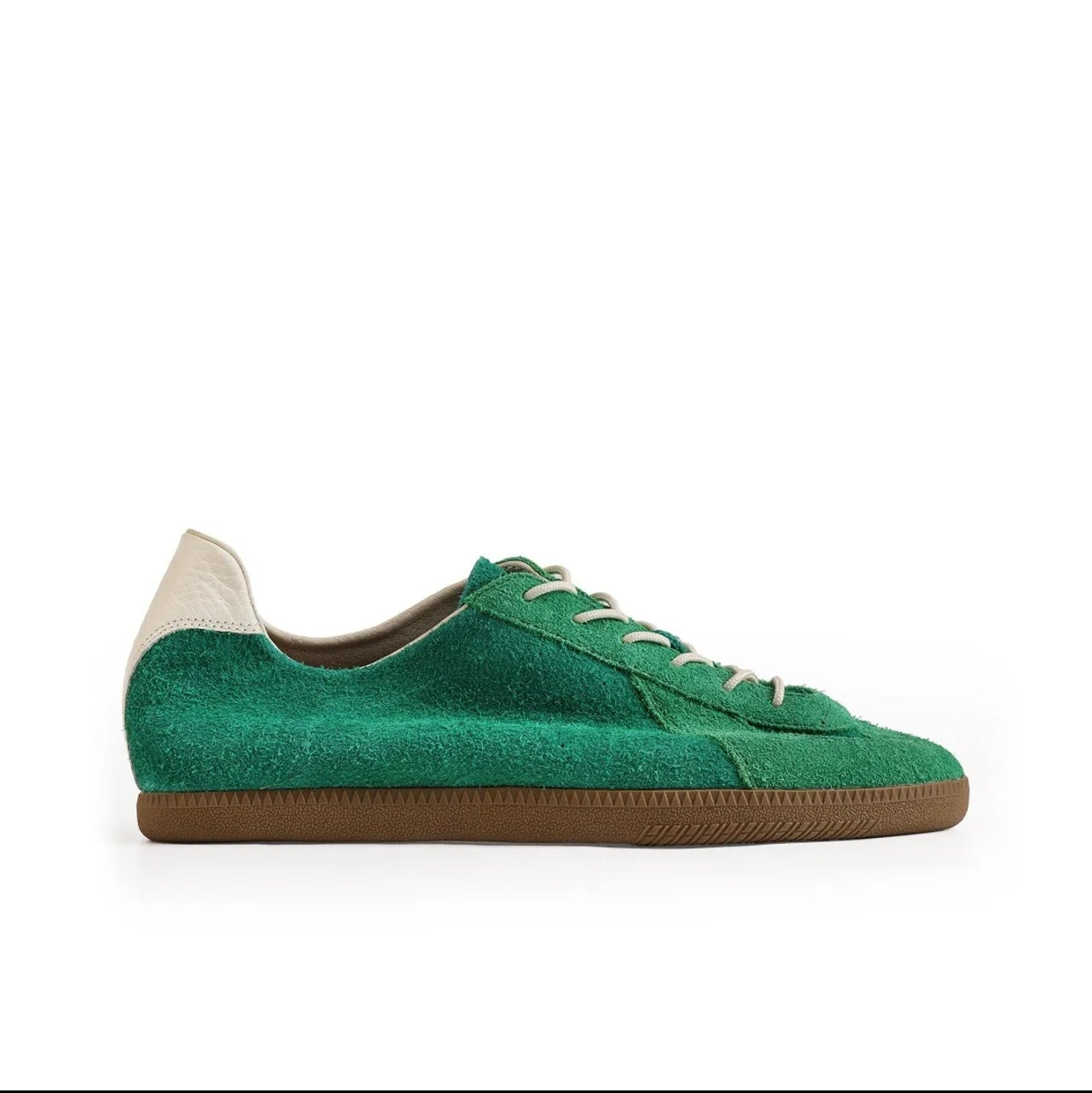 A green suede low-top sneaker with white laces and a brown gum sole, shown on a white background within a mobile app screenshot. Text below reads 'WILLOW CREEK 5217'.