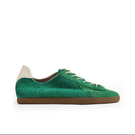 A green suede low-top sneaker with white laces and a brown gum sole, shown on a white background within a mobile app screenshot. Text below reads 'WILLOW CREEK 5217'.
