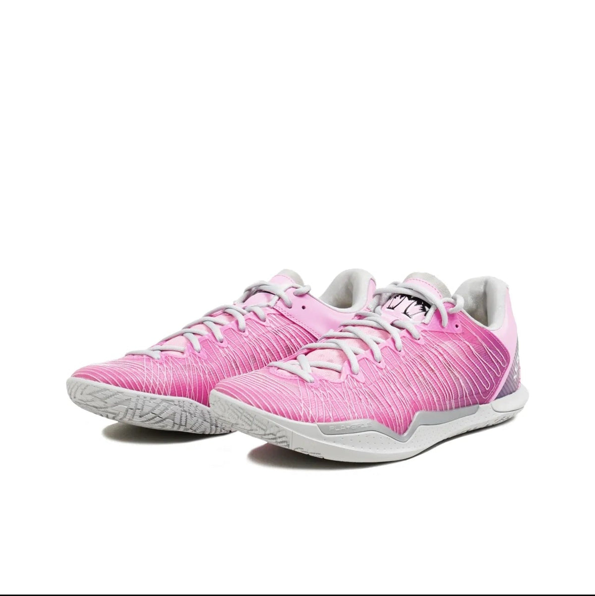 A pair of pink athletic sneakers with white laces and white soles, displayed on a clean white background.