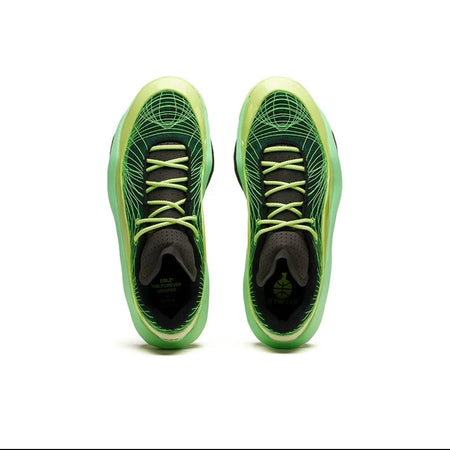 A pair of athletic shoes shown from the sole/top-down view, featuring a bright green and black design with textured patterns and matching green laces, centered on a white background.