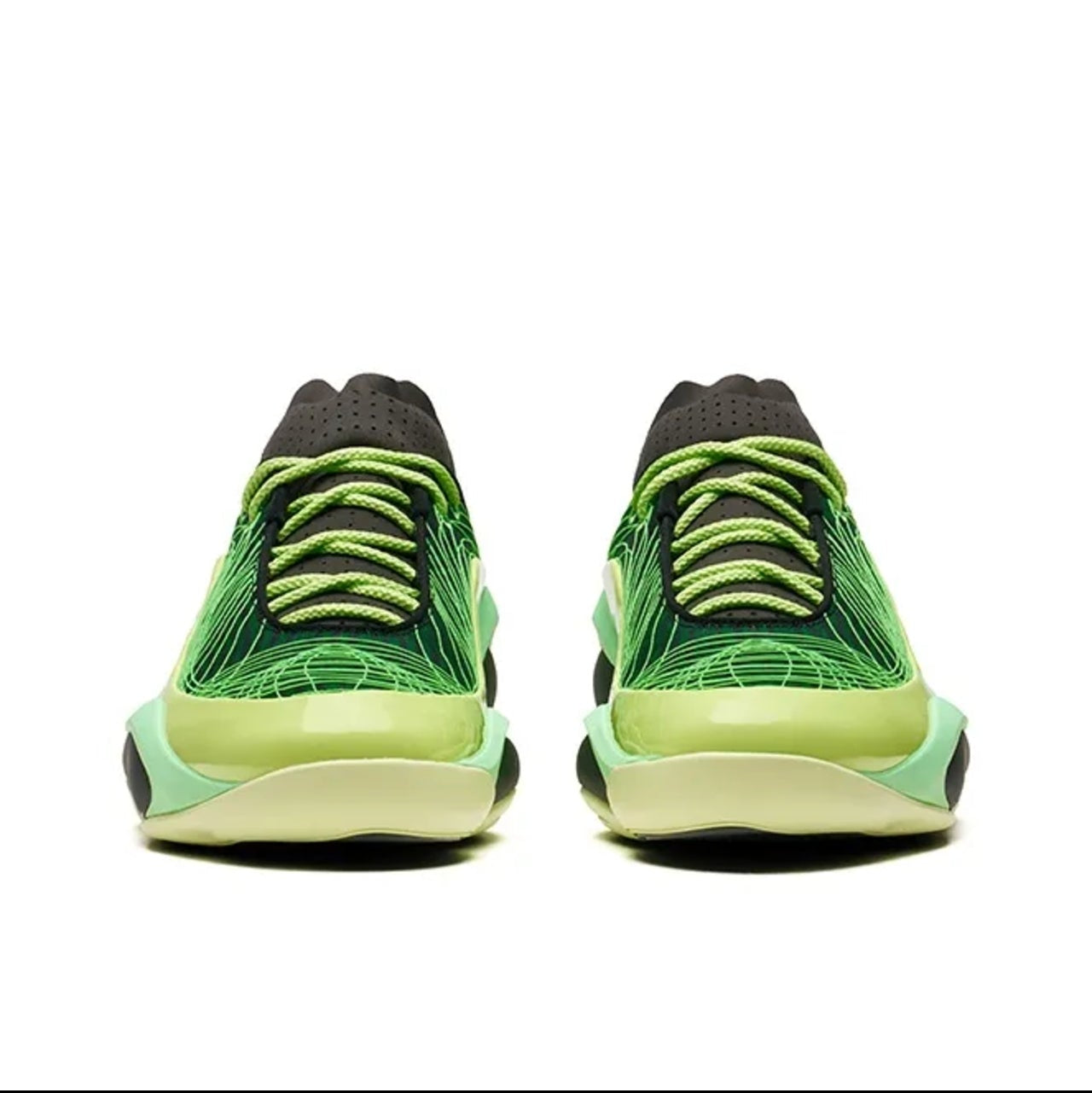 A pair of low-top sneakers shown from the back, featuring a bright green and lime-yellow patterned upper with black laces and a thick white midsole.