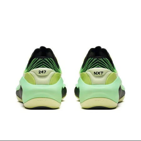 A pair of 247 sneakers shown from the back, featuring a light green and black upper with a yellow-green midsole and the '247' and 'NXT' logos visible.