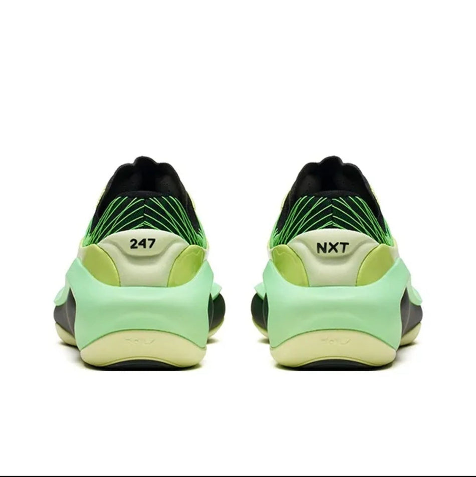 A pair of 247 sneakers shown from the back, featuring a light green and black upper with a yellow-green midsole and the '247' and 'NXT' logos visible.