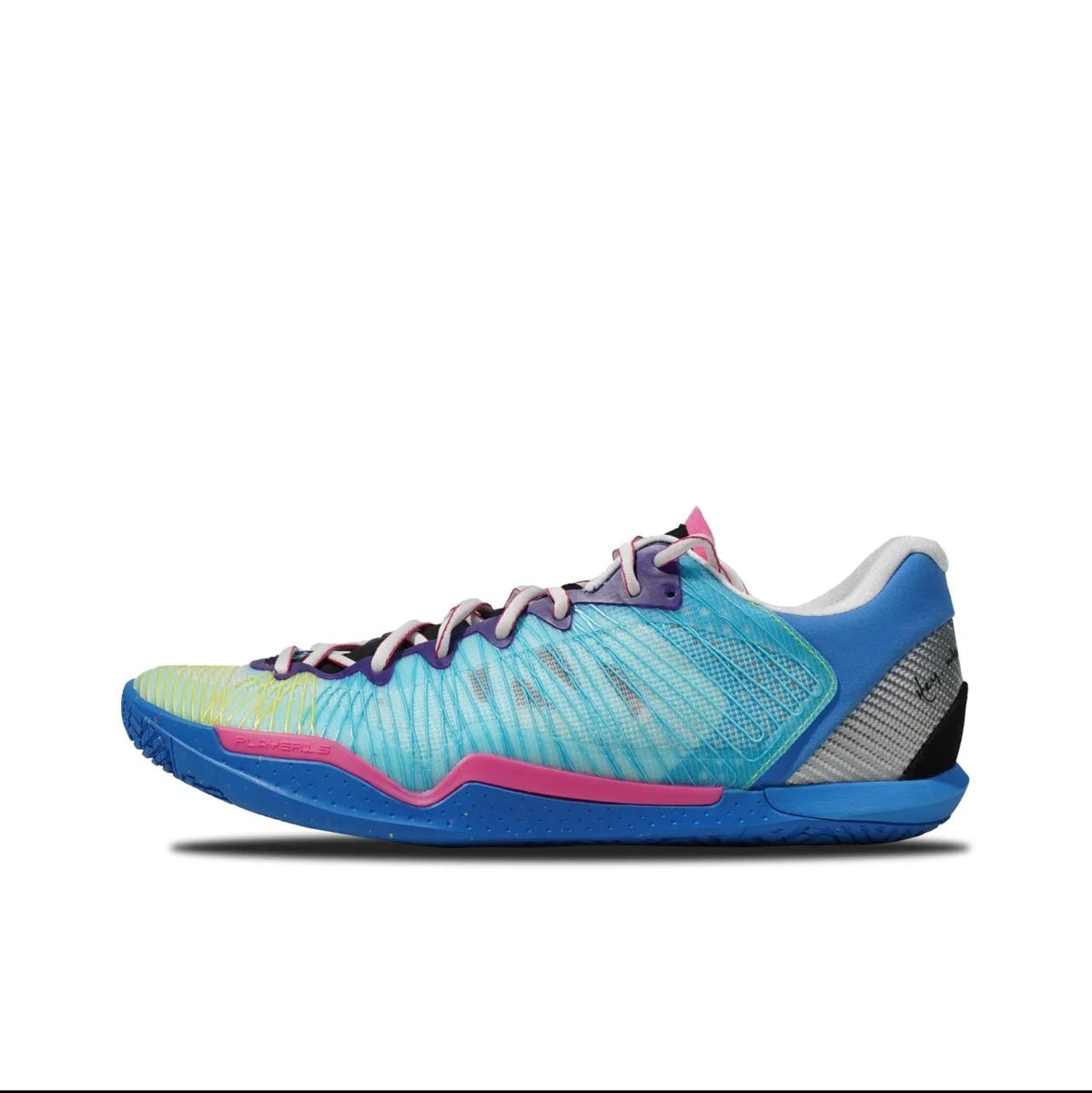 A Nike basketball shoe in a blue, purple, and green colorway, shown from the side profile on a white background. The shoe features a textured blue and purple upper with green accents on the toe, a pink midsole accent, and a dark gray heel.