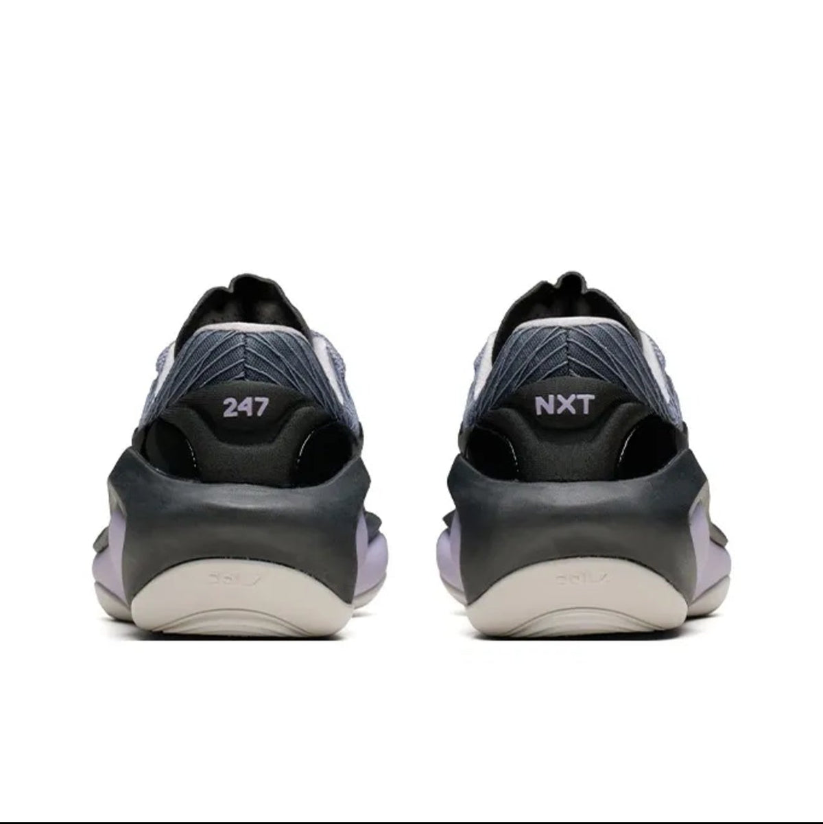 A pair of black and dark gray Nike sneakers shown from the back, with the '247' and 'NXT' logos visible on the heel, set against a plain white background.