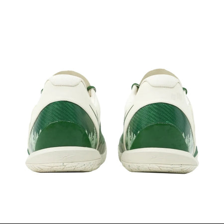 A pair of white sneakers shown from the back, featuring glossy dark green heel panels and white soles, displayed on a white background within a mobile app screenshot.