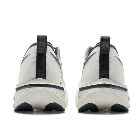 A pair of white low-top sneakers shown from the back, featuring black heel pulls and black outsole details, displayed on a white background within a mobile app screenshot.