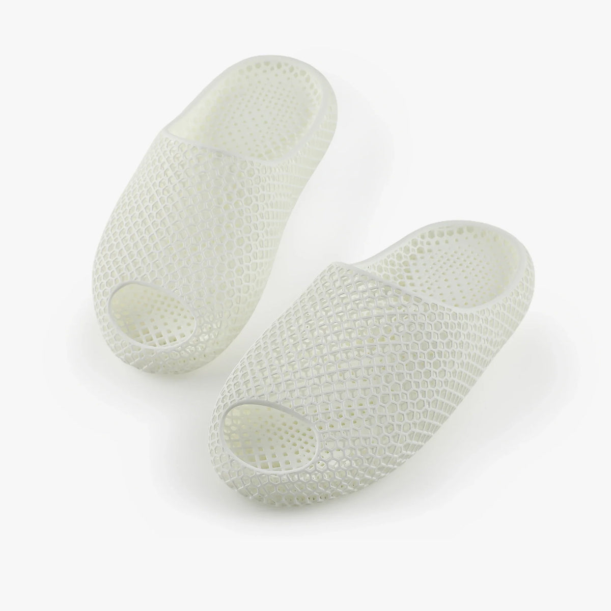 3D printed slippers, white pair with oval toe openings and textured upper