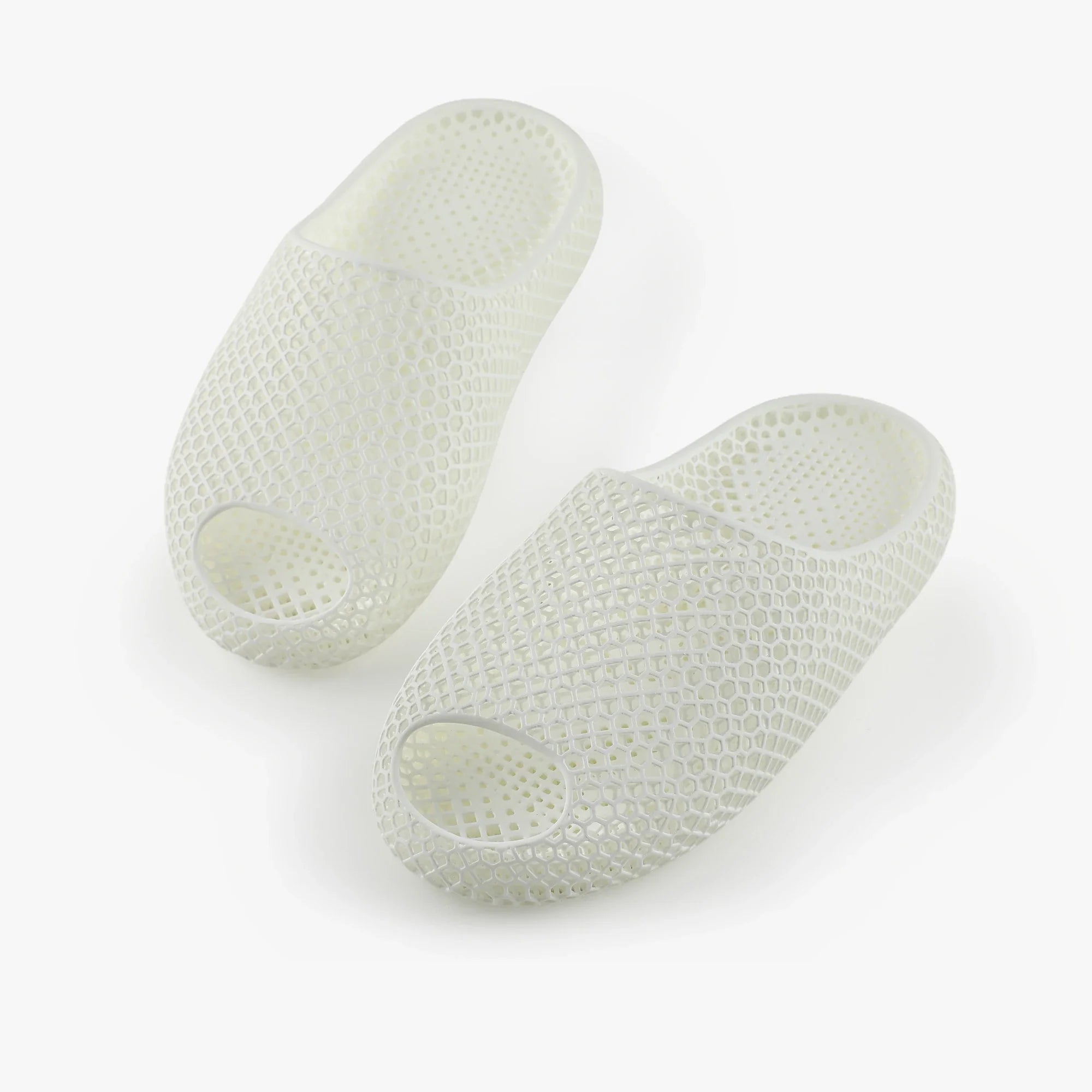 3D printed slippers, white pair with oval toe openings and textured upper